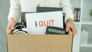 hands holding a box of item with sign that says i quit on the box